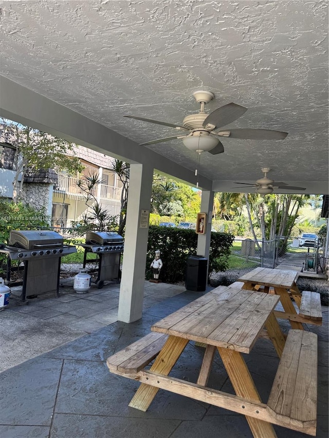 view of patio / terrace with ceiling fan and a grill