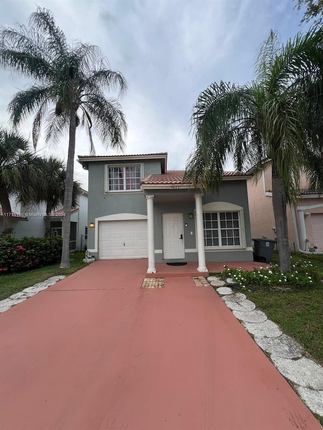 mediterranean / spanish house with a garage