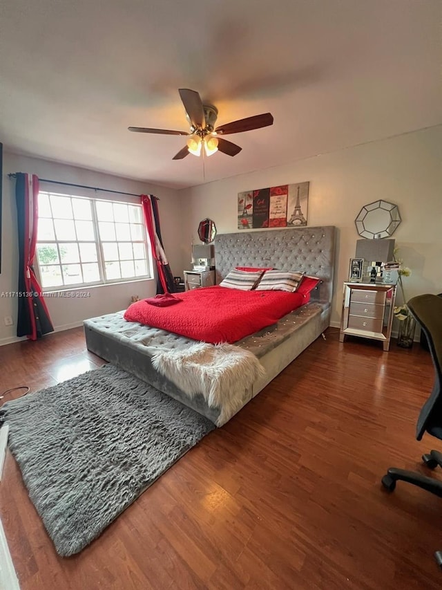 bedroom with ceiling fan and dark wood-type flooring