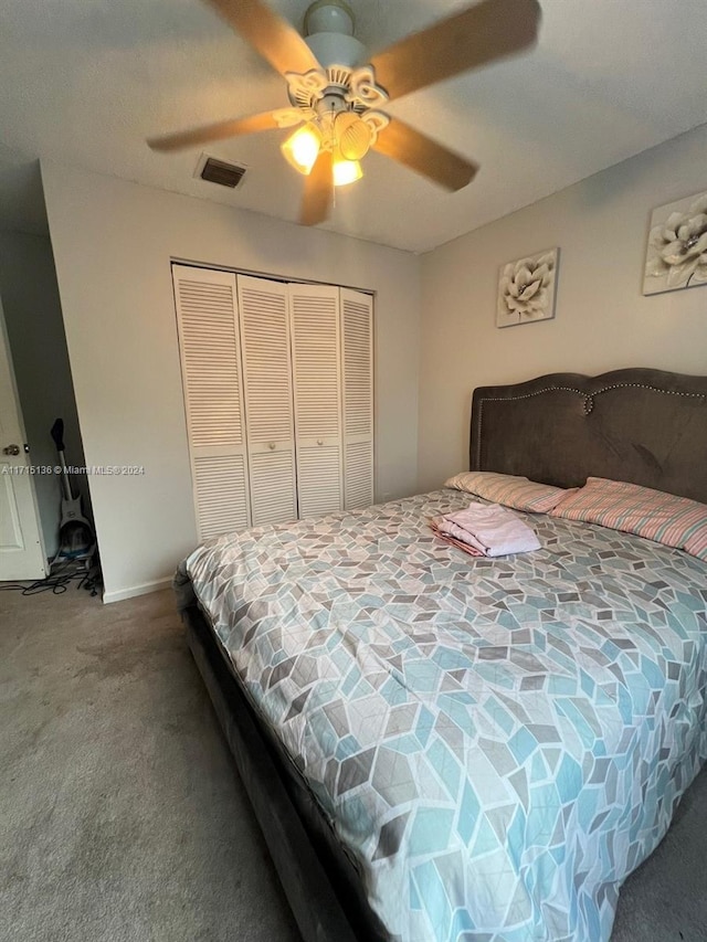 carpeted bedroom featuring ceiling fan and a closet