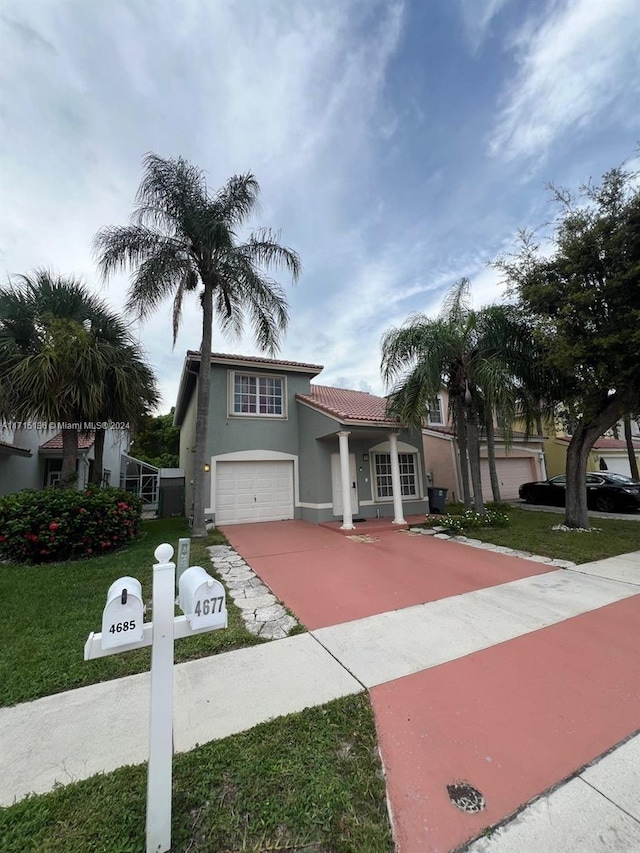 mediterranean / spanish house featuring a garage and a front lawn