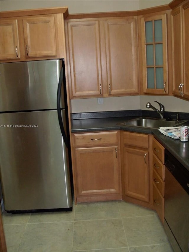 kitchen with sink, light tile patterned flooring, and stainless steel appliances