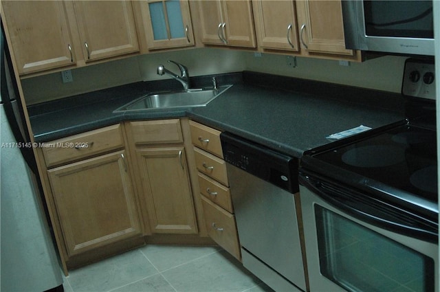 kitchen with stainless steel dishwasher, sink, electric stove, light tile patterned floors, and fridge