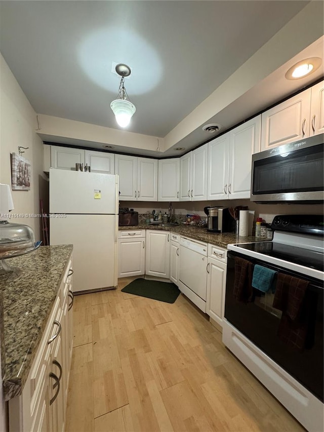 kitchen with white appliances, sink, light hardwood / wood-style flooring, white cabinetry, and hanging light fixtures