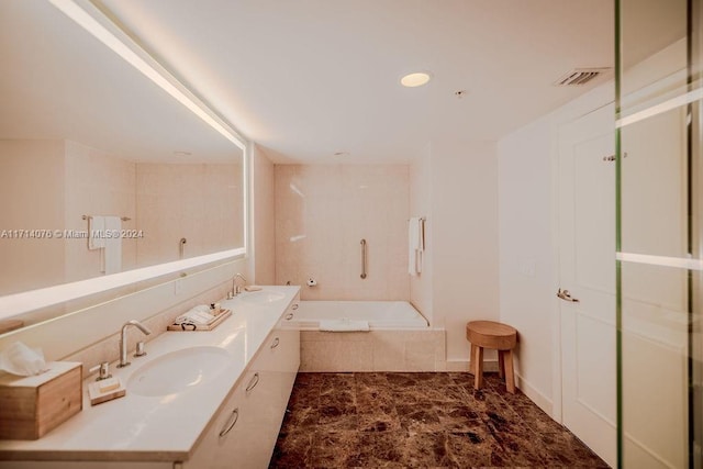 bathroom with vanity and a relaxing tiled tub