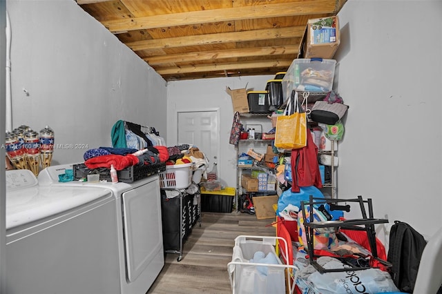 clothes washing area featuring hardwood / wood-style floors, wood ceiling, and washing machine and clothes dryer