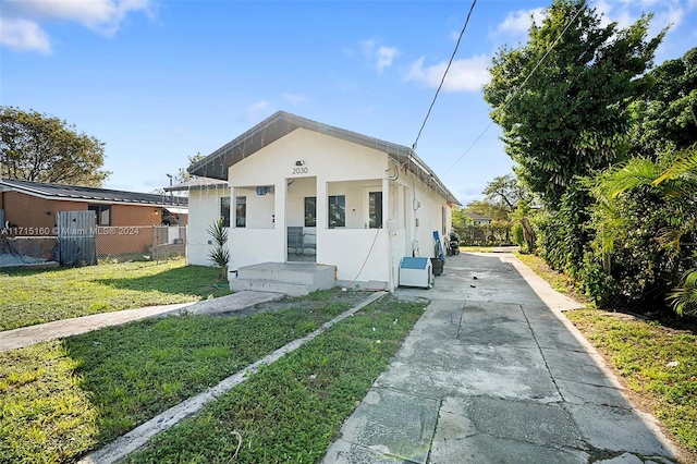 bungalow-style house with a front yard