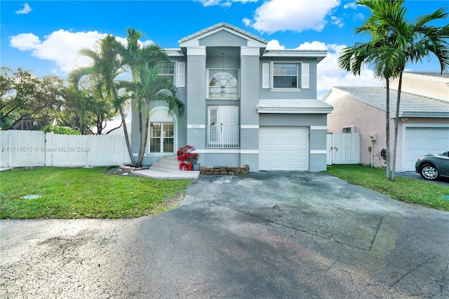 view of front of house featuring a front lawn and a garage