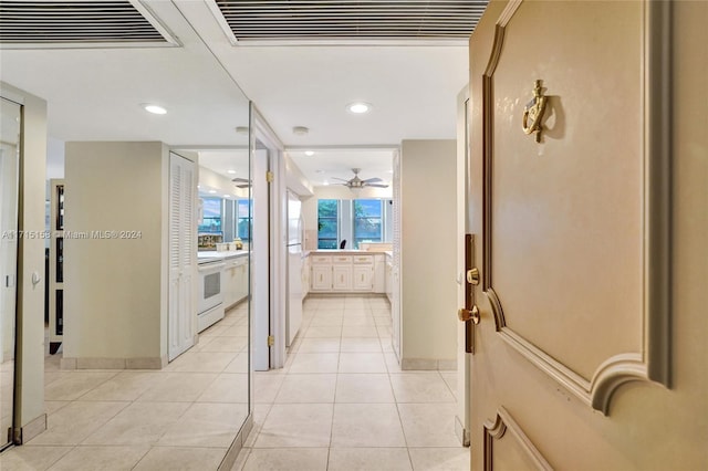 hall featuring light tile patterned floors