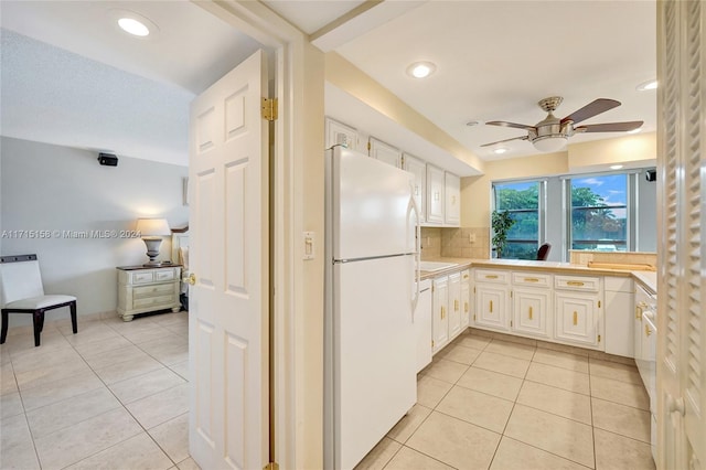 kitchen with backsplash, white cabinetry, ceiling fan, and white refrigerator