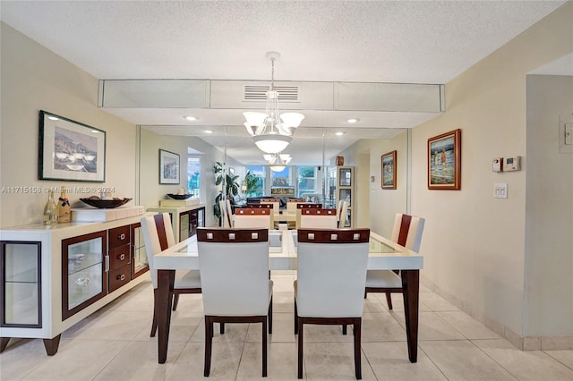 dining room with a chandelier, a textured ceiling, beverage cooler, and light tile patterned flooring