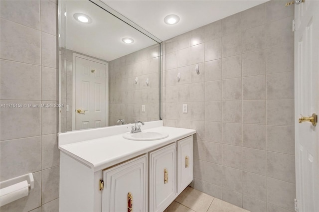 bathroom featuring tile patterned flooring, vanity, and tile walls