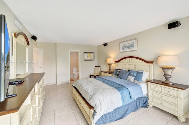 tiled bedroom with connected bathroom