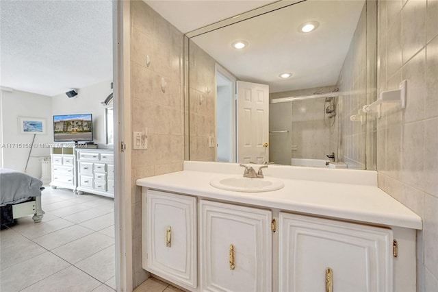 bathroom featuring vanity, tile patterned floors, and tile walls