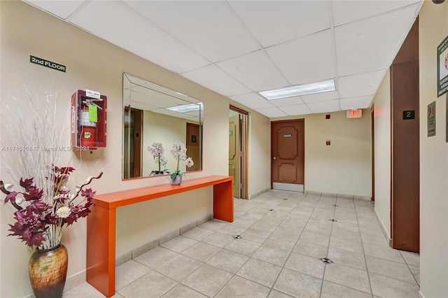 hallway featuring a paneled ceiling