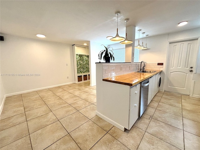 kitchen featuring wood counters, tasteful backsplash, sink, decorative light fixtures, and dishwasher