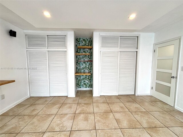 unfurnished bedroom with light tile patterned floors