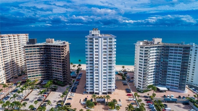 aerial view with a water view and a beach view