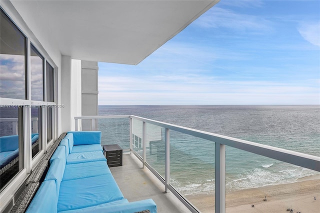 balcony with a water view and outdoor lounge area