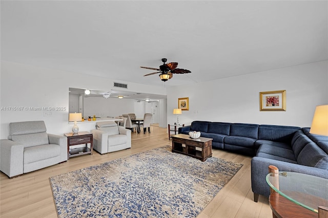 living room with ceiling fan and hardwood / wood-style flooring