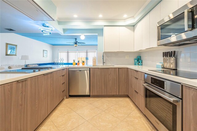 3750 Galt Ocean Dr Unit 1602, Fort Lauderdale, FL 33308 - kitchen featuring stainless steel appliances, modern cabinets, light countertops, and ornamental molding