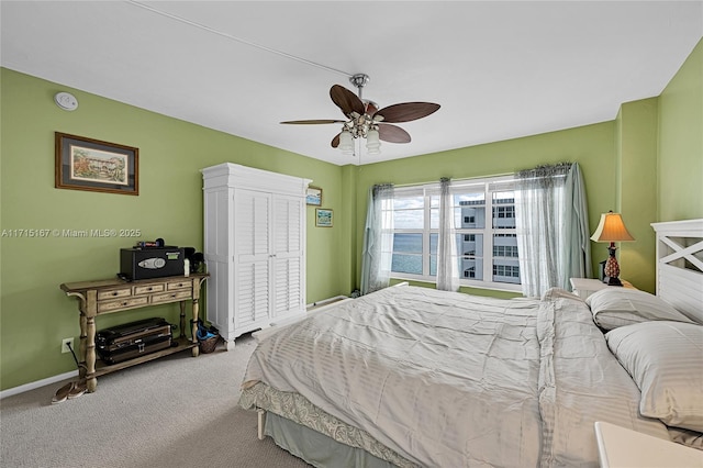 bedroom with ceiling fan, carpet flooring, and a closet