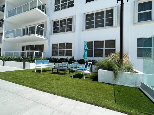 view of swimming pool featuring a water view and a patio area