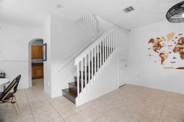 stairs featuring tile patterned flooring