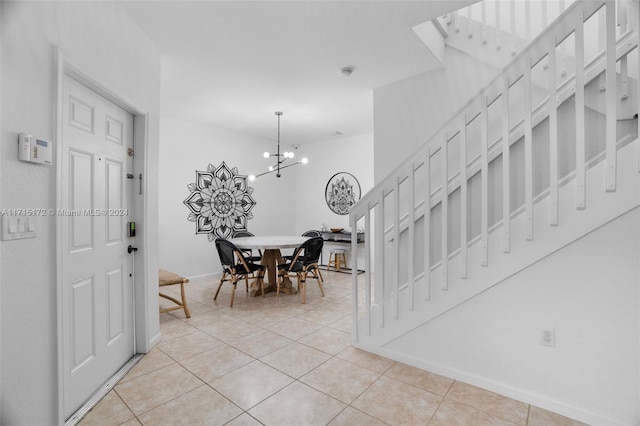 dining area with light tile patterned floors and a notable chandelier