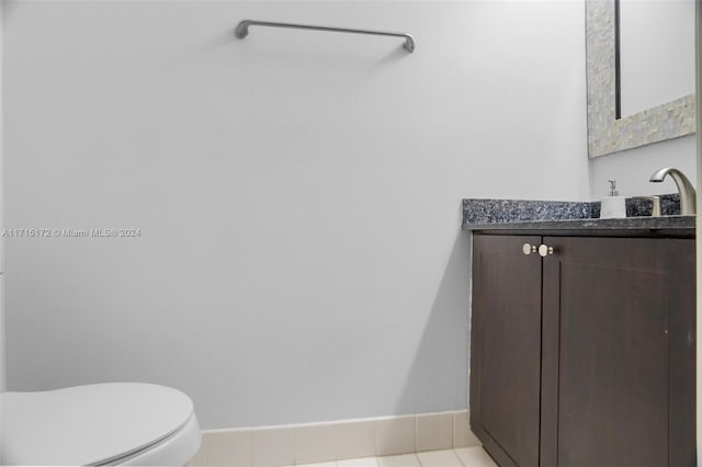 bathroom with tile patterned floors, vanity, and toilet