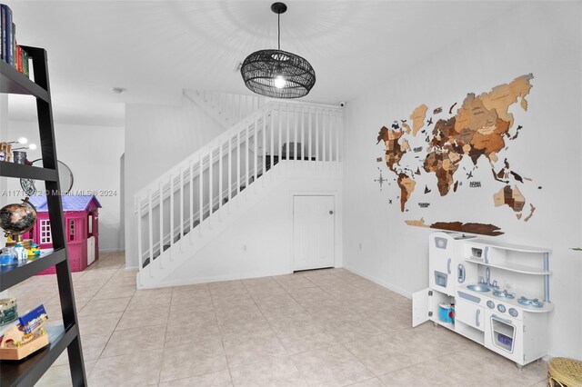 staircase featuring a chandelier