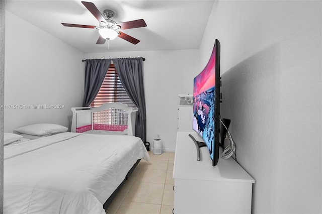 tiled bedroom featuring ceiling fan