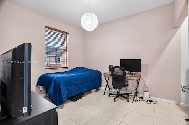 tiled bedroom featuring a chandelier