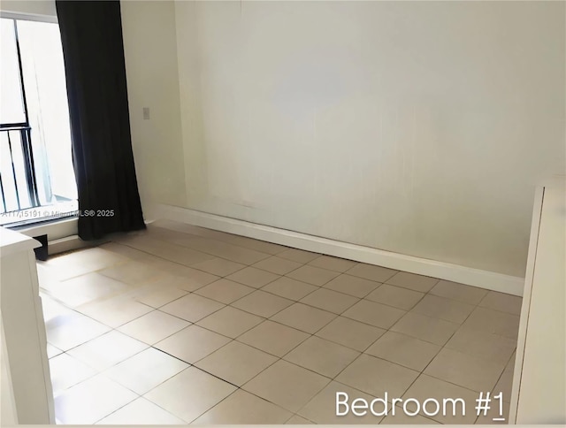 unfurnished room with light tile patterned floors