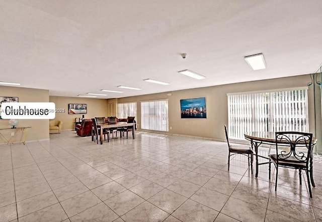 tiled dining space featuring a healthy amount of sunlight