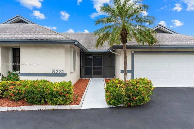 doorway to property with a garage