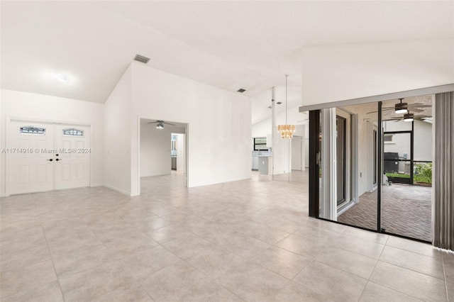 unfurnished room featuring lofted ceiling and a notable chandelier