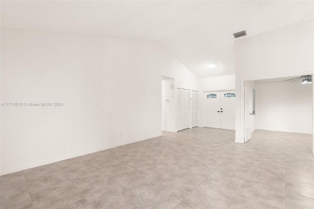 unfurnished room featuring ceiling fan and high vaulted ceiling