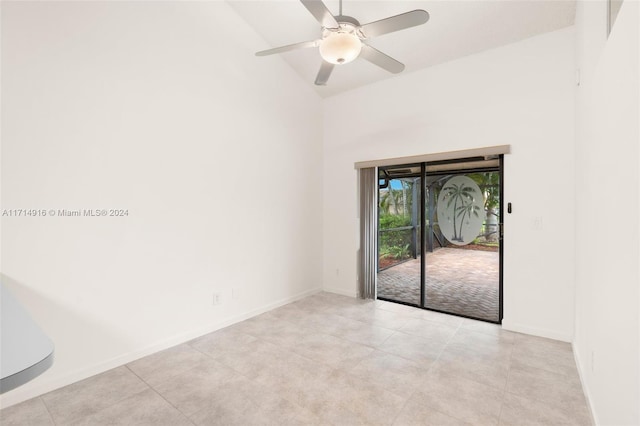 spare room with ceiling fan and light tile patterned flooring