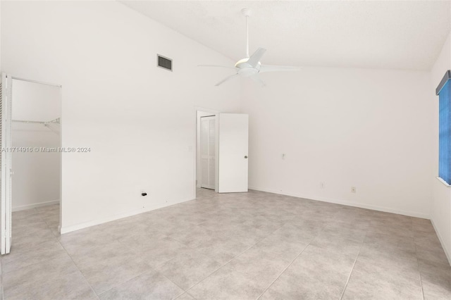 empty room featuring ceiling fan and high vaulted ceiling