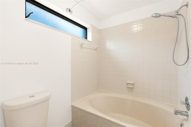 bathroom featuring bathtub / shower combination and toilet