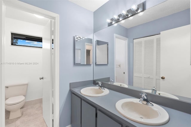 bathroom with tile patterned floors, vanity, and toilet