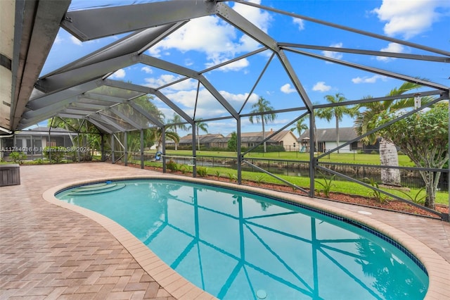 view of pool featuring a patio area and glass enclosure