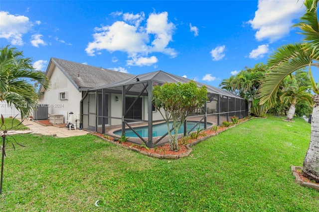 view of swimming pool with glass enclosure, a patio area, and a yard