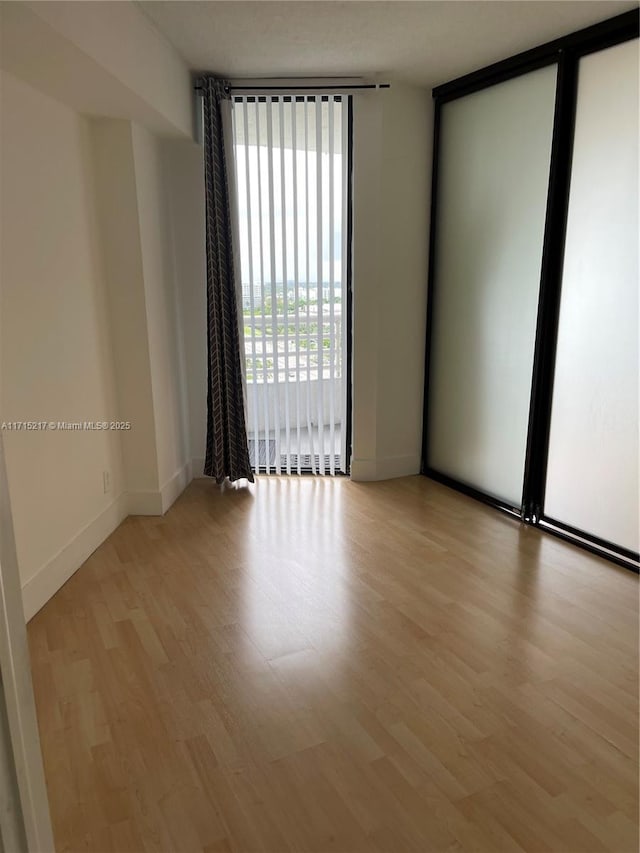 spare room featuring light hardwood / wood-style flooring