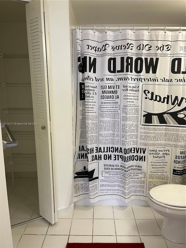 bathroom featuring toilet and tile patterned floors