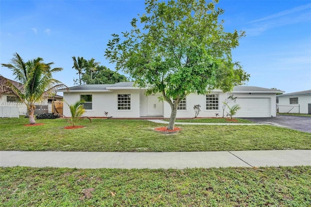 view of front of home featuring a front yard and a garage