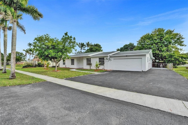 single story home with a front yard and a garage