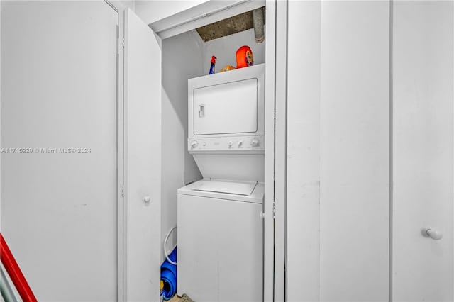 laundry area featuring stacked washer and dryer