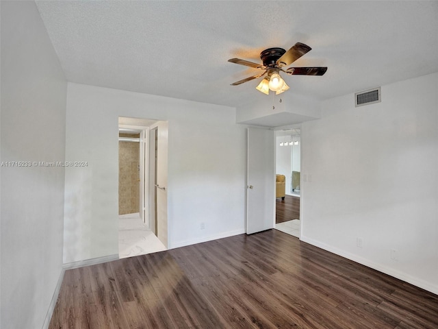 empty room featuring ceiling fan, hardwood / wood-style floors, and a textured ceiling